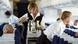 Flight attendants serve drinks on a plane Flight attendants serve drinks on a plane