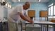 A man leans over to put his ballot paper in a ballot box on a low table. Nicosia, Cyprus, June 9, 2024 A man leans over to put his ballot paper in a ballot box on a low table. Nicosia, Cyprus, June 9, 2024