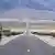 A long view of a scenic road in a barren landscape
