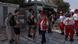 Members of the Hellenic Red Cross hand over bottles of water to tourists who line up to visit the Acropolis hill Members of the Hellenic Red Cross hand over bottles of water to tourists who line up to visit the Acropolis hill