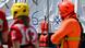 A live vest hangs on a boat and rescue personnel stand, out of focus, in the foreground A live vest hangs on a boat and rescue personnel stand, out of focus, in the foreground