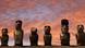 Easter Island: Moai statues with a dark red evening sky in the background Easter Island: Moai statues with a dark red evening sky in the background