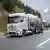 A Daimler C02 neutral GenH2 truck in a promo shot on a motorway