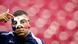Kylian Mbappe points to the French logo on his face mask Kylian Mbappe points to the French logo on his face mask