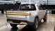 A silver Rivian pick-up truck seen from behind at a Plymouth, Michigan, manufacturing facility A silver Rivian pick-up truck seen from behind at a Plymouth, Michigan, manufacturing facility