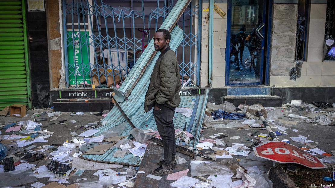 Man standing amid general debris