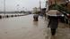 People wade through a flooded road along the bank of overflowing Bagmati River following heavy rains in Kathmandu People wade through a flooded road along the bank of overflowing Bagmati River following heavy rains in Kathmandu