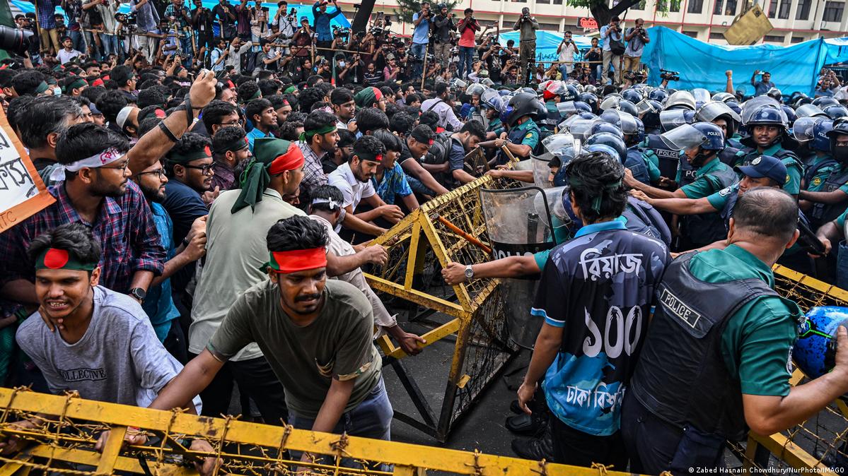 Students push against police barricades at a protest rally in Dhaka. Students push against police barricades at a protest rally in Dhaka.