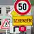 A sign reading Schengen amid traffic signs