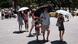 Tourists are using umbrellas to protect from the sun during a heatwave in Athens, Greece Tourists are using umbrellas to protect from the sun during a heatwave in Athens, Greece