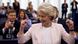 Ursula von der Leyen smiles as she raises both fists in the air Ursula von der Leyen smiles as she raises both fists in the air
