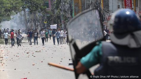 Students clash with riot police in Dhaka