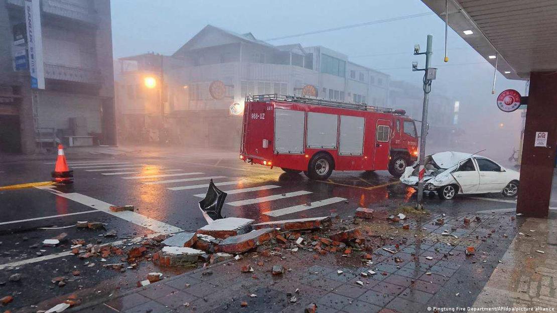 A destroyed road and car can be seen in Taiwan.