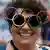 A fan at the Paris 2024 Olympic opening ceremony wearing Olympic glasses