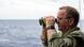 Boris Pistorius looking through binoculars in a file photo from 2024