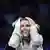Olga Kharlan reacts by holding her hands to her head after a fencing victory