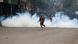 A police officer runs next to a cloud of tear gas during an anti-government protest in Nairobi A police officer runs next to a cloud of tear gas during an anti-government protest in Nairobi