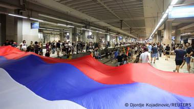 Activists spread a huge Serbian flag in an underground station