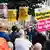 A large group of people standing in Liverpool holding anti-racism signs