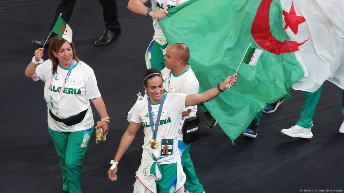 Imane Khelif holds a flag