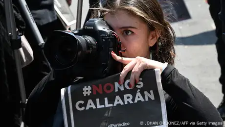 Protester in Guatemala City takes a photo during a protest in March 2023.