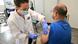 A nurse gives a man an mpox vaccination shot A nurse gives a man an mpox vaccination shot