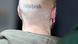A man with a shaved head, seen from behind, with a tattoo that reads "Skinhead" A man with a shaved head, seen from behind, with a tattoo that reads "Skinhead"