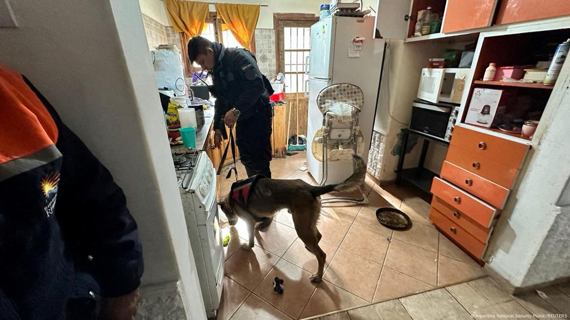 Handout photo shows a police officer searching a home during a raid as Argentina's Federal Police was dismantling what it said was a terrorist cell