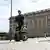 A police officer on a Segway patrols Sweden's parliament in Stockholm, Thursday Aug. 17, 2023.