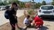 A Bosnian Red Cross volunteer (right) puts a bandage around the knee of a Moroccan migrant while his two companions watch A Bosnian Red Cross volunteer (right) puts a bandage around the knee of a Moroccan migrant while his two companions watch