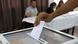 A voter casts a ballot at a polling station in Algiers. A voter casts a ballot at a polling station in Algiers.