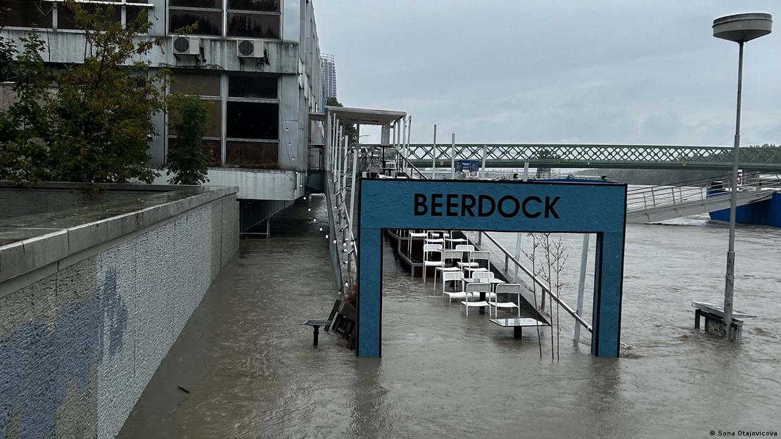 Chairs and tables on a ramp are surrounded by floodwater. In the background are a bridge and a building, Bratislava, Slovakia, September 2024 Chairs and tables on a ramp are surrounded by floodwater. In the background are a bridge and a building, Bratislava, Slovakia, September 2024