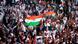 A crowd waves Indian flags at a Modi speech in New York A crowd waves Indian flags at a Modi speech in New York
