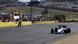 Nelson Piquet's car crosses the finish line on a race track Nelson Piquet's car crosses the finish line on a race track