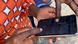 Two people in Kenya are looking at a smartphone together