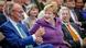 Friedrich Merz (left) and Angela Merkel (center) smile during a celebration of Merkel's 70th birthday