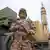 A member of the Revolutionary Guard stands in front of Shahab-3 missile