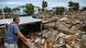 A man looks over distruction brought on by Hurricane Helene A man looks over distruction brought on by Hurricane Helene