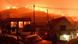 Residents watch flames rising from a wildfire burns next to the village of Kallithea, near Corinth, Greece Residents watch flames rising from a wildfire burns next to the village of Kallithea, near Corinth, Greece