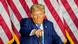 Republican presidential candidate and former President Donald Trump in front of a US flag