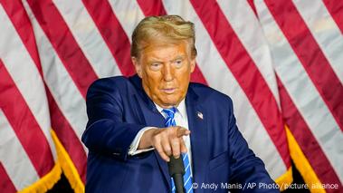 Republican presidential candidate and former President Donald Trump in front of a US flag