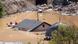 A rubber boat goes past the roof of a submerged house A rubber boat goes past the roof of a submerged house