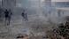 About ten men are seen running away from danger on a rubble-filled street in Beirut About ten men are seen running away from danger on a rubble-filled street in Beirut