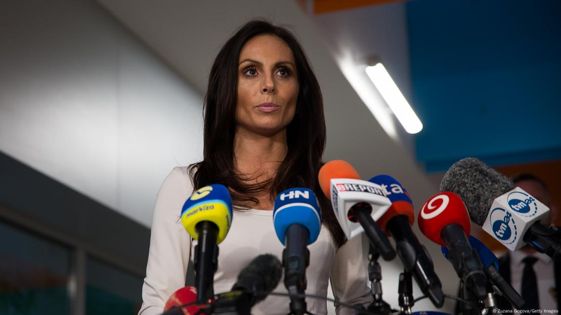 Slovak Minister of Health Zuzana Dolinkova stands behind a battery of microphones. The picture was taken on May 15, 2024 after Prime Minister Robert Fico was critically injured in an assassination attempt.