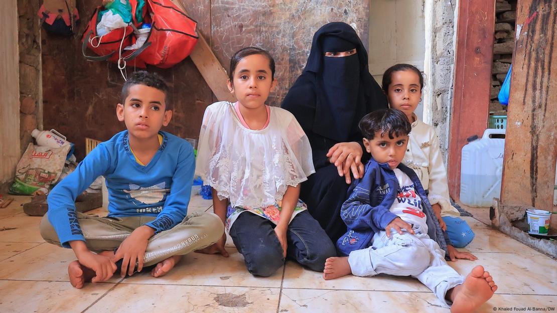 A Yemeni family is sitting on the floor, looking sad