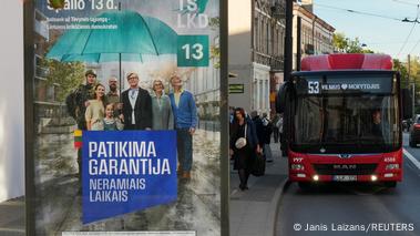 Family: An election poster at a bus stop in Vilnius shows Lithuania's Prime Minister Ingrida Simonyte (center) with her family under an umbrella