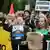 Protesters hold up signs to demand the right to decent housing in Madrid 