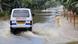 An ambulance makes its way through floodwaters in Assam state, India An ambulance makes its way through floodwaters in Assam state, India