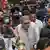 Omar Abdullah walks through a crowd before addressing the media in Srinagar