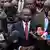 Kenya's interior minister Kithure Kindiki speaking in front of microphones